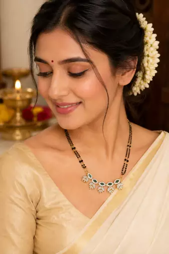 Double strand black bead mangalsutra with green & white cz floral pendant, gold-toned