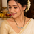 Double strand black bead mangalsutra with green & white cz floral pendant, gold-toned