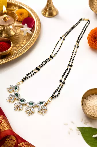 Double strand black bead mangalsutra with green & white cz floral pendant, gold-toned