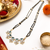 Double strand black bead mangalsutra with green & white cz floral pendant, gold-toned