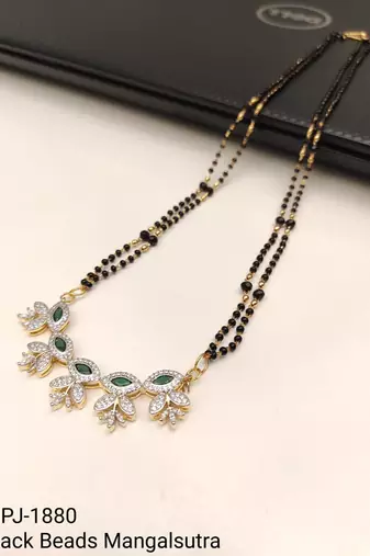 Double strand black bead mangalsutra with green & white cz floral pendant, gold-toned