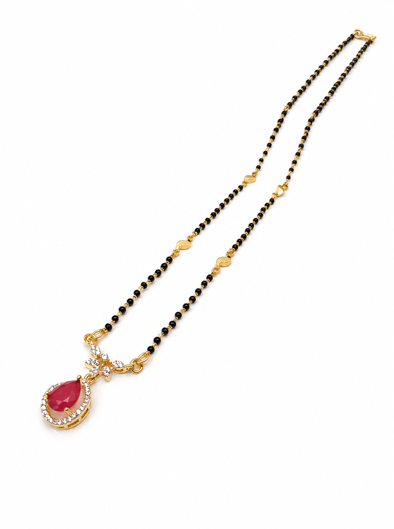 Gold-toned mangalsutra with ruby red teardrop pendant, black bead chain, cz stone accents
