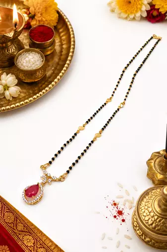 Gold-toned mangalsutra with ruby red teardrop pendant, black bead chain, cz stone accents