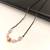 Black bead mangalsutra with rose quartz stones and gold-toned filigree pendant, traditional indian necklace