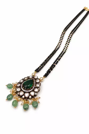 Double strand black bead mangalsutra with kundan pendant, green stone & pearl drops