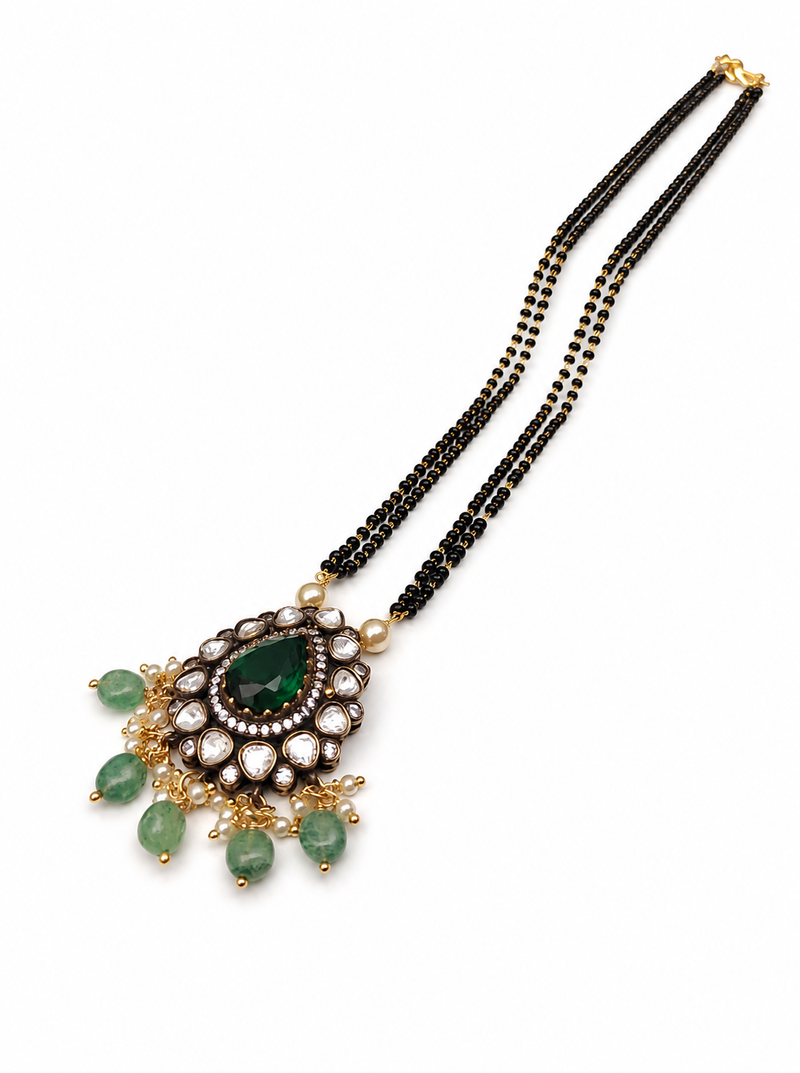 Double strand black bead mangalsutra with kundan pendant, green stone & pearl drops