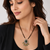 Double strand black bead mangalsutra with kundan pendant, green stone & pearl drops