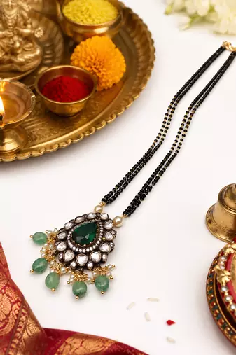 Double strand black bead mangalsutra with kundan pendant, green stone & pearl drops