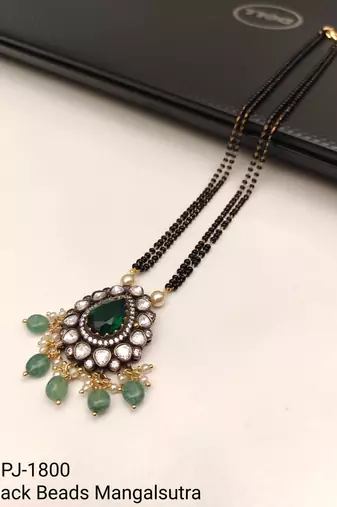 Double strand black bead mangalsutra with kundan pendant, green stone & pearl drops