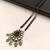 Double strand black bead mangalsutra with kundan pendant, green stone & pearl drops