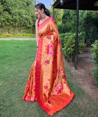 traditional orange silk blend saree with vibrant floral motifs   2