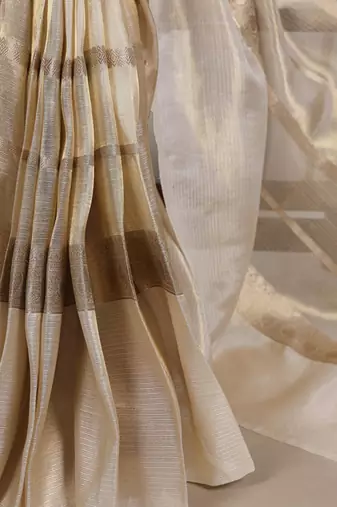 Beige tissue woven saree with zari work