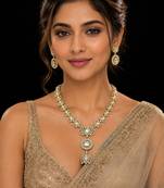 Elegant kundan-inspired gold-tone necklace set with statement pendant & matching earrings