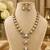 Elegant kundan-inspired gold-tone necklace set with statement pendant & matching earrings