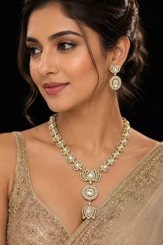Elegant kundan-inspired gold-tone necklace set with statement pendant & matching earrings