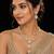 Elegant kundan-inspired gold-tone necklace set with statement pendant & matching earrings