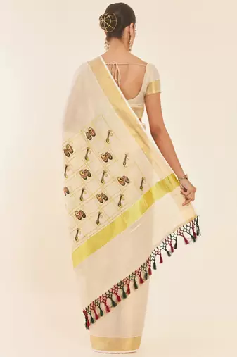 Off white ethnic motifs printed zari tissue kasavu saree