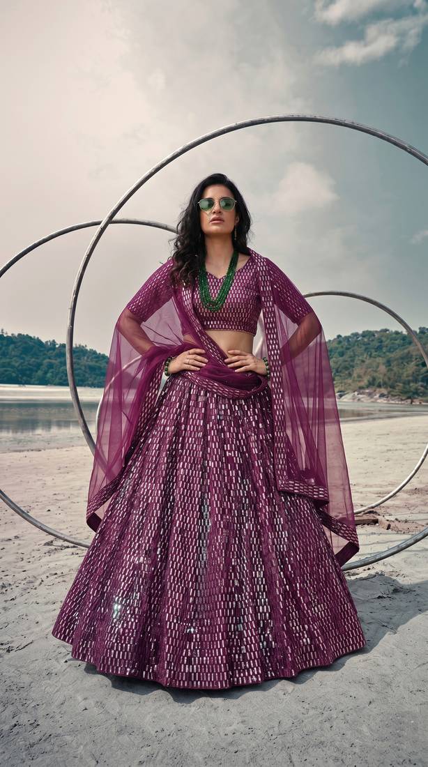 Purple net lehenga with un-stitched blouse party wedding wear