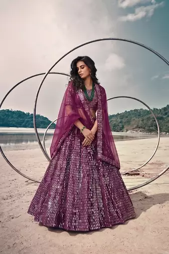 Purple net lehenga with un-stitched blouse party wedding wear