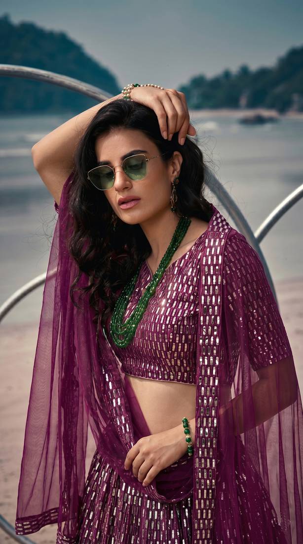 Purple net lehenga with un-stitched blouse party wedding wear