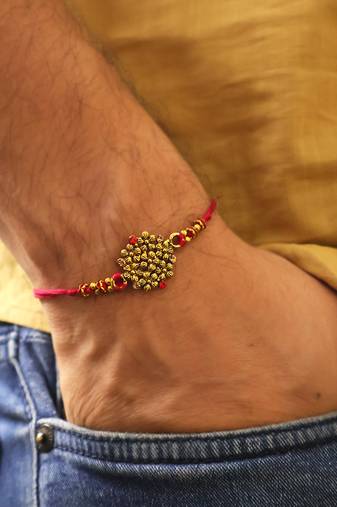 Golden bead cluster traditional rakhi with roli chawal capsules