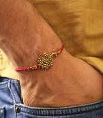 Golden bead cluster traditional rakhi with roli chawal capsules