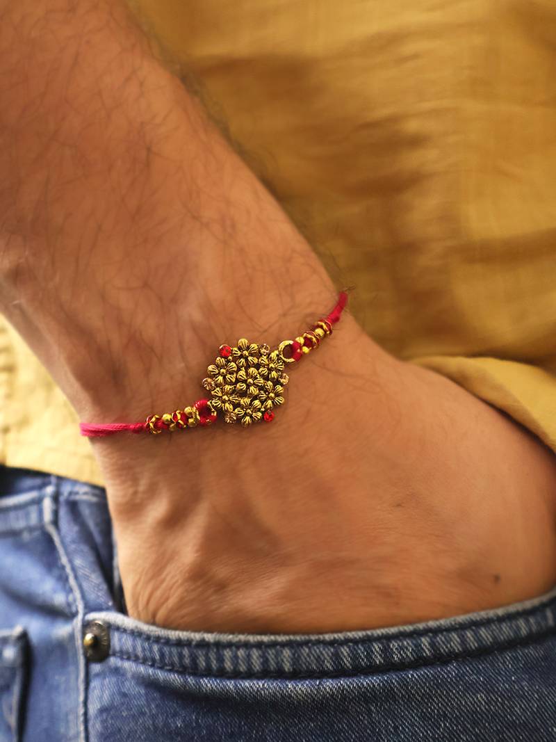 Golden bead cluster traditional rakhi with roli chawal capsules