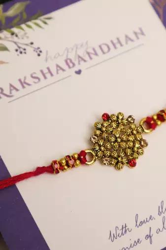 Golden bead cluster traditional rakhi with roli chawal capsules