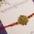 Golden bead cluster traditional rakhi with roli chawal capsules