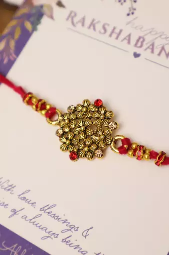 Golden bead cluster traditional rakhi with roli chawal capsules