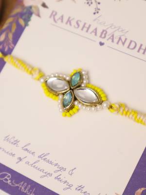 Yellow kundan floral pearl rakhi with roli chawal capsules 2