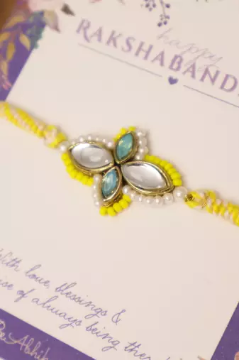 Yellow kundan floral pearl rakhi with roli chawal capsules