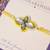 Yellow kundan floral pearl rakhi with roli chawal capsules