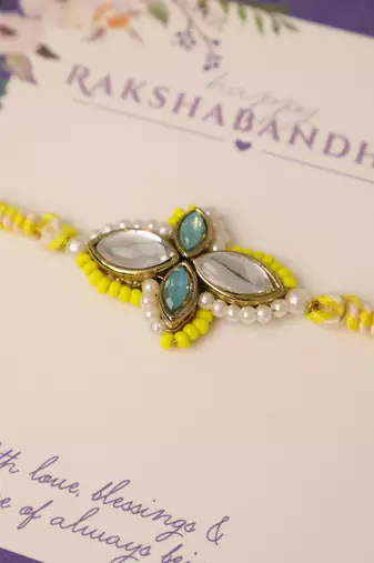 Yellow kundan floral pearl rakhi with roli chawal capsules