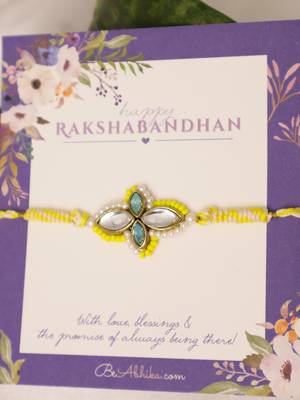 Yellow kundan floral pearl rakhi with roli chawal capsules 4