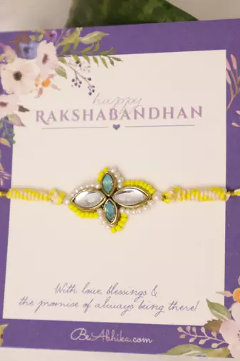 Yellow kundan floral pearl rakhi with roli chawal capsules