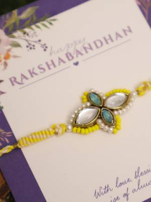 Yellow kundan floral pearl rakhi with roli chawal capsules 5