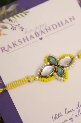 Yellow kundan floral pearl rakhi with roli chawal capsules