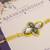 Yellow kundan floral pearl rakhi with roli chawal capsules