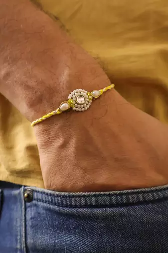 Pearl kundan halo designer rakhi with roli chawal capsules