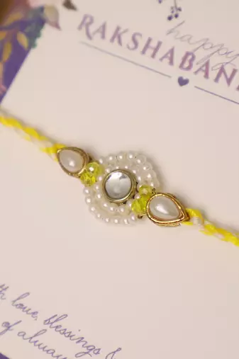 Pearl kundan halo designer rakhi with roli chawal capsules