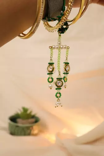 Emerald kundan pearl tassel designer lumba with roli chawal capsules