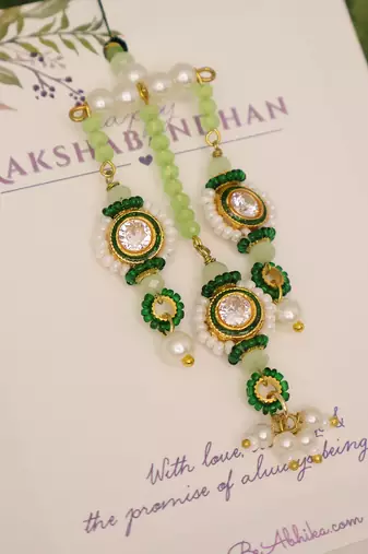 Emerald kundan pearl tassel designer lumba with roli chawal capsules