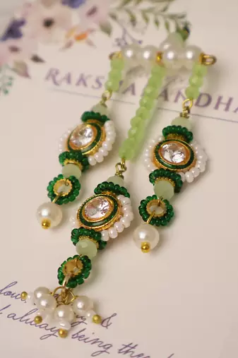 Emerald kundan pearl tassel designer lumba with roli chawal capsules