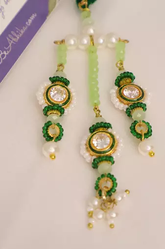 Emerald kundan pearl tassel designer lumba with roli chawal capsules