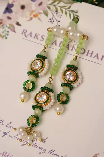 Emerald kundan pearl tassel designer lumba with roli chawal capsules