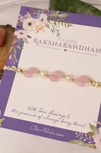 Pink pearl beaded designer rakhi with roli chawal capsules