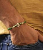 Green beaded floral charm rakhi with roli chawal capsules