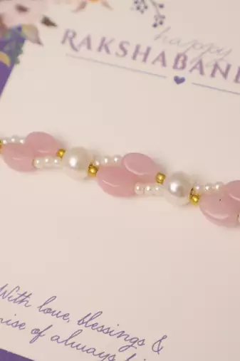 Pink pearl beaded designer rakhi with roli chawal capsules