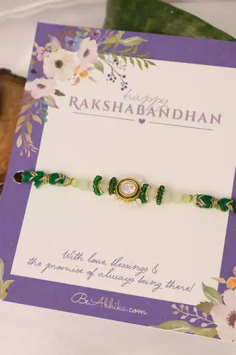Green beaded floral charm rakhi with roli chawal capsules